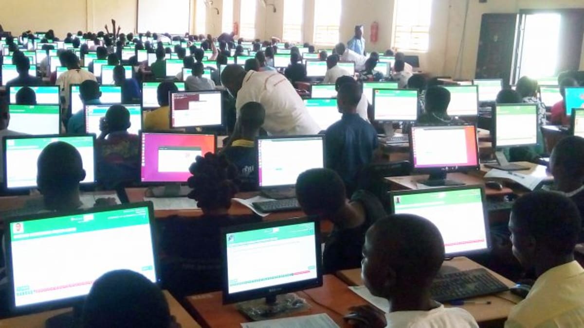 Nigerian students working on computers during university entrance examination at organized testing center