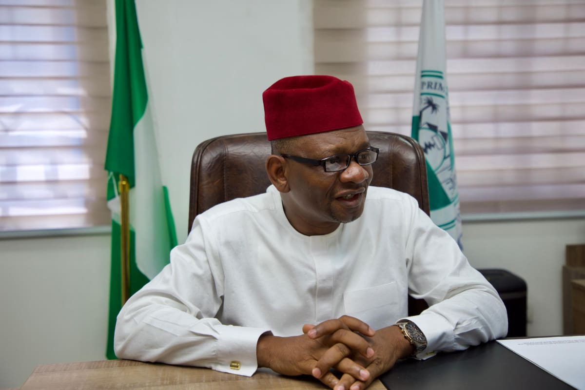 Nigerian healthcare workers at a primary health clinic reviewing financial documents and digital systems