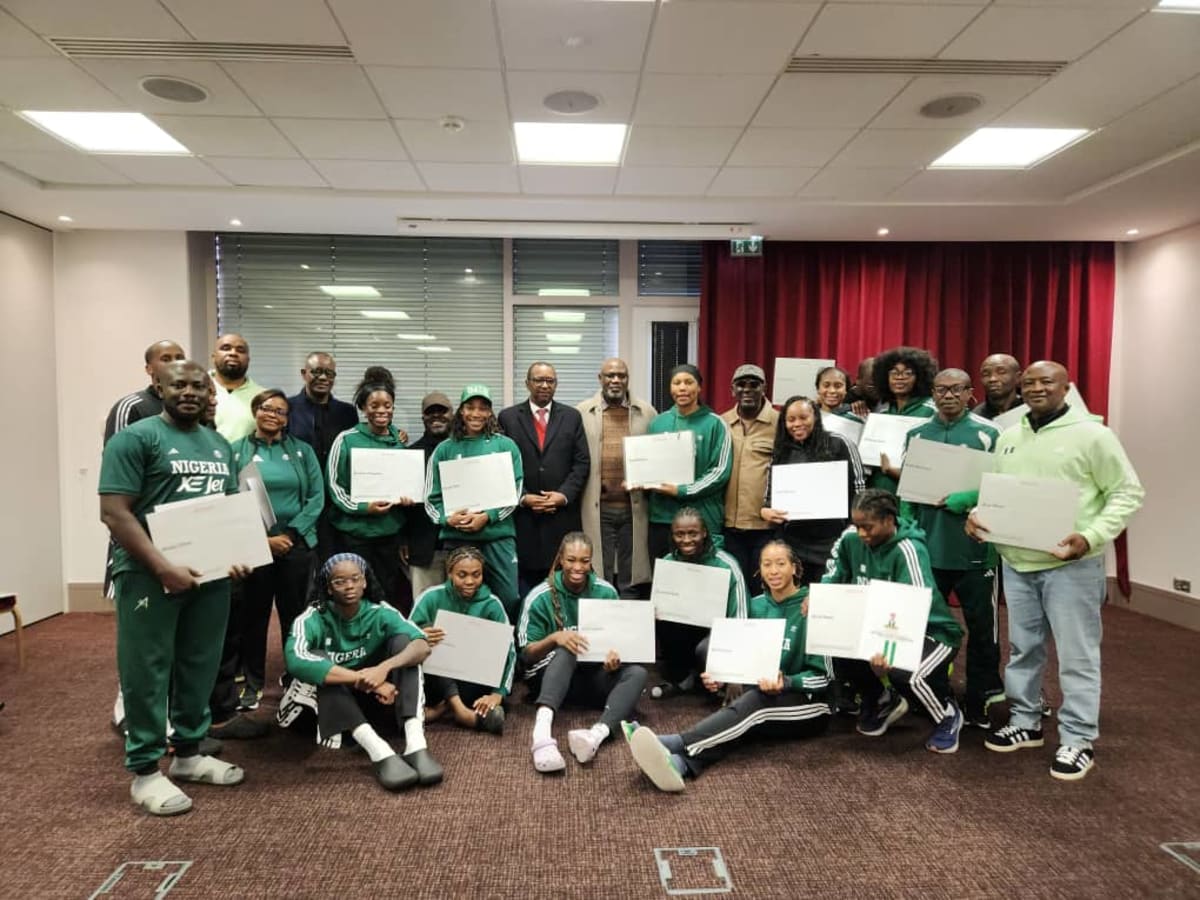 Nigerian government officials presenting house documents to D'Tigress basketball team captain in Lyon France