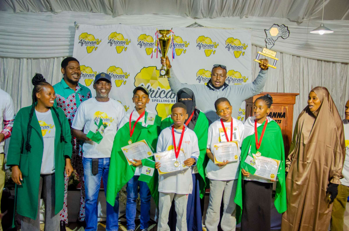 Nigerian students celebrating with medals and trophy at African Spelling Bee competition in Zimbabwe