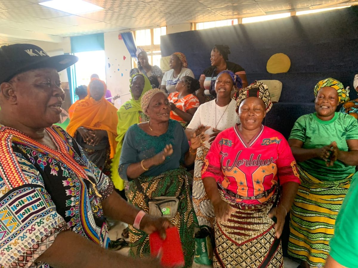 Makoko widows celebrate while receiving food aid packages on International Women's Day in Lagos