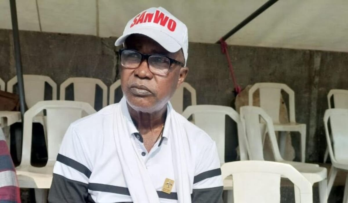 Nigerian football players observing moment of silence on soccer field in tribute