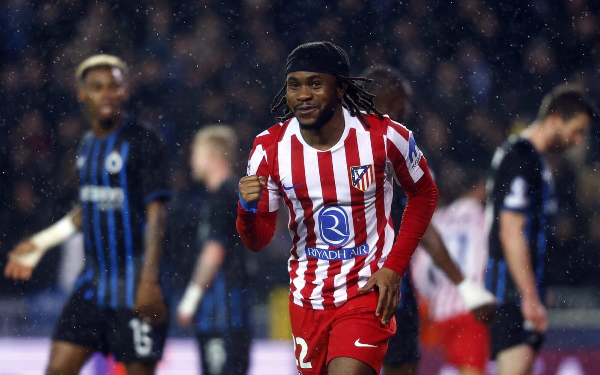 Ademola Lookman celebrating in Atlético Madrid red and white striped jersey after scoring
