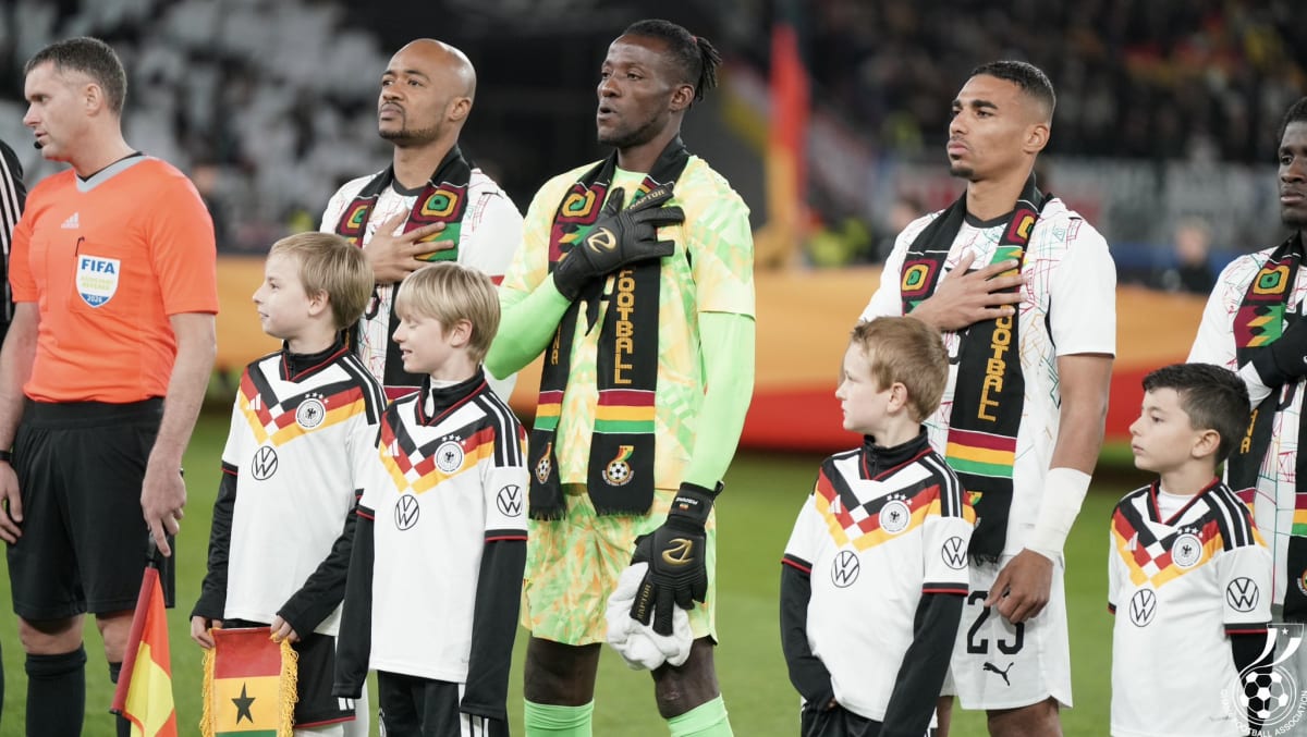 Carlos Queiroz in coaching attire looking determined on sideline during international football match