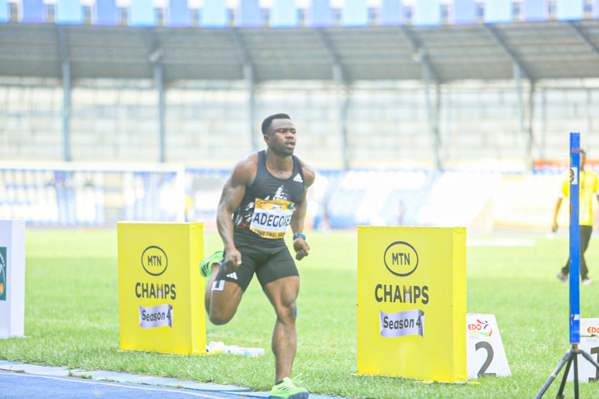 Two Nigerian sprinters crossing finish line simultaneously at MTN CHAMPS Grand Final in Ibadan