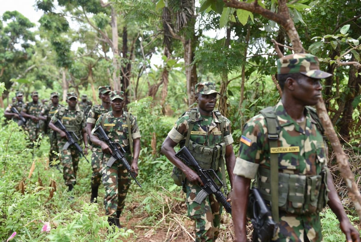 Nigerian soldiers in uniform standing at attention during military ceremony honoring their service
