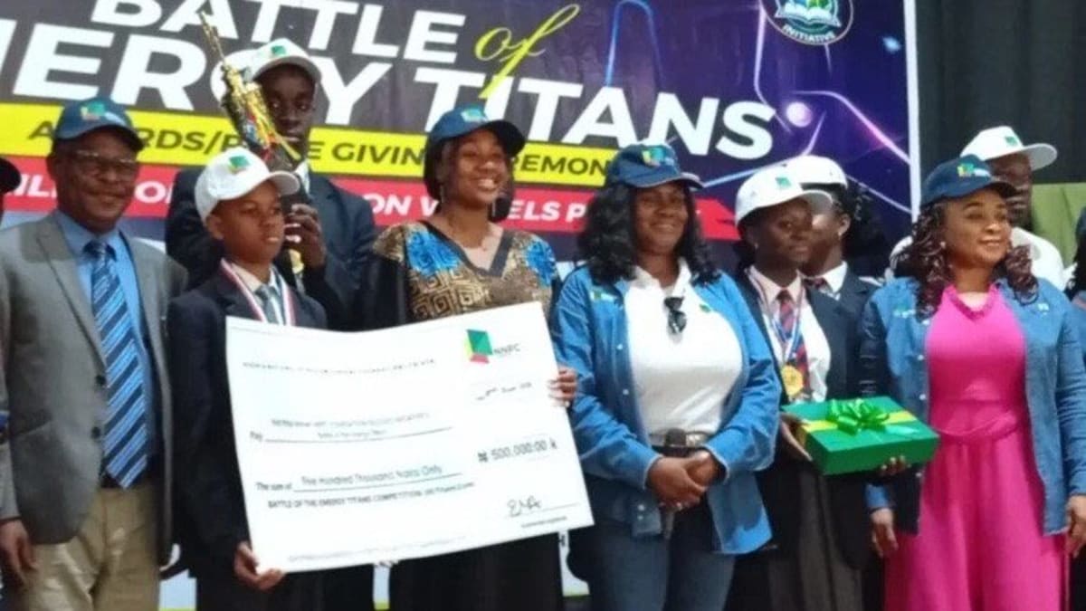 Nigerian students from Premiere Academy celebrating their energy innovation competition victory with trophy