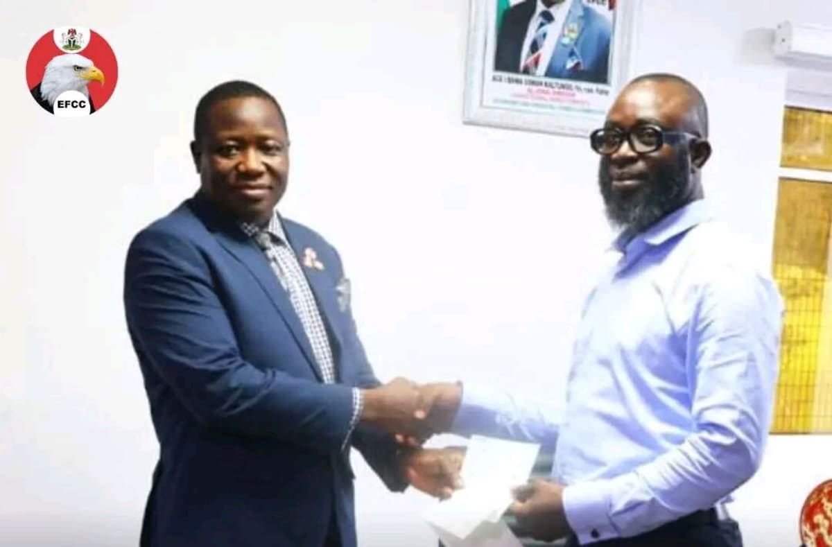 ** Nigerian Economic and Financial Crimes Commission officials presenting bank drafts to fraud victim