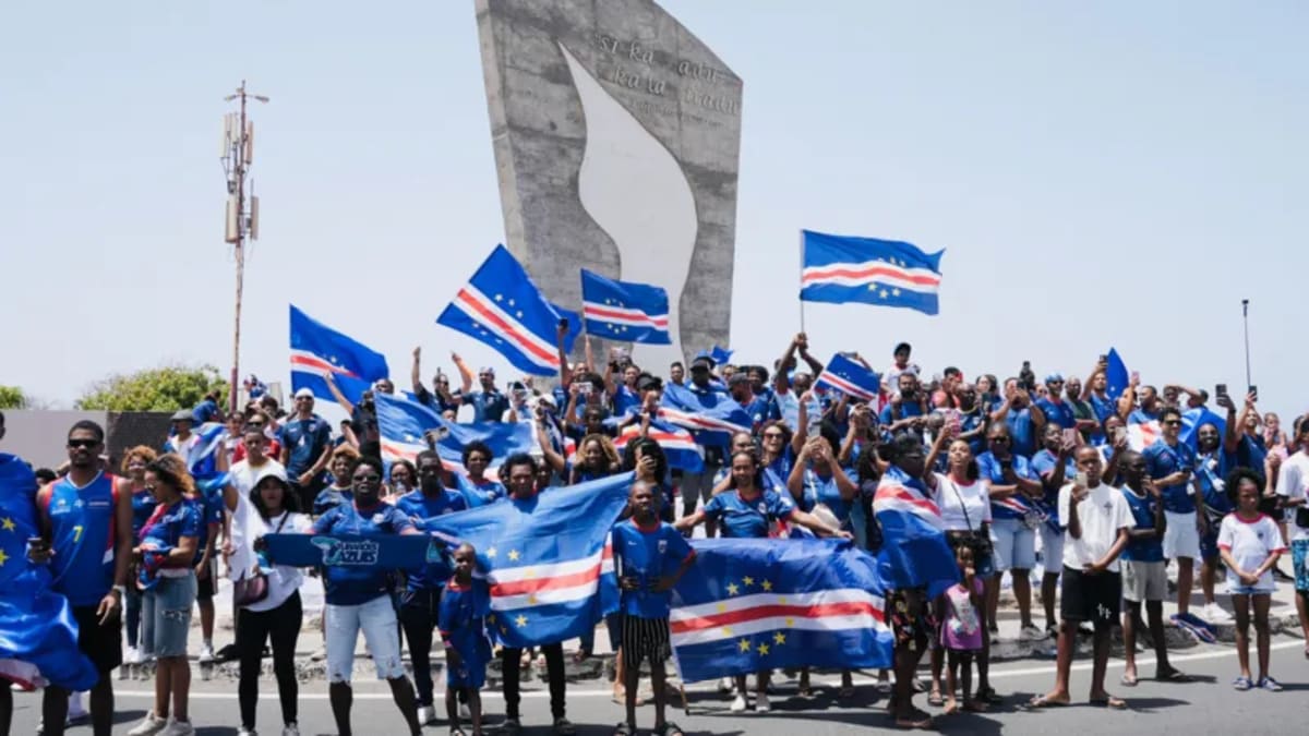 Cape Verde soccer fans celebrate with flags and drums at Praia airport welcoming team home