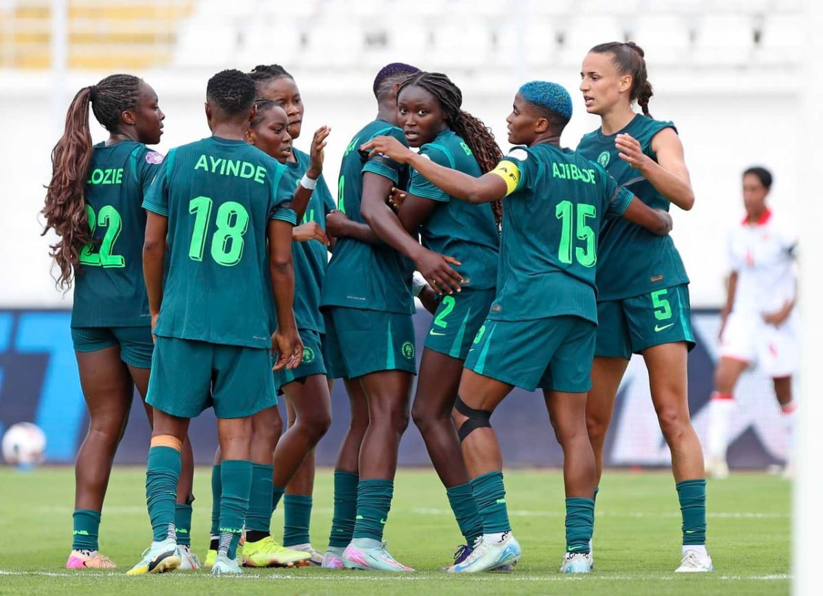 Nigerian women's football team celebrating with trophy after winning Women's Africa Cup championship
