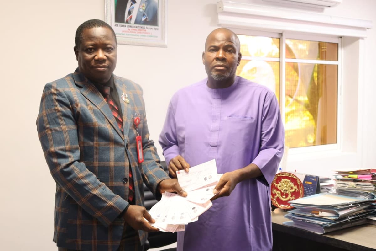 EFCC officials presenting bank drafts to businessman at restitution ceremony in Lagos, Nigeria