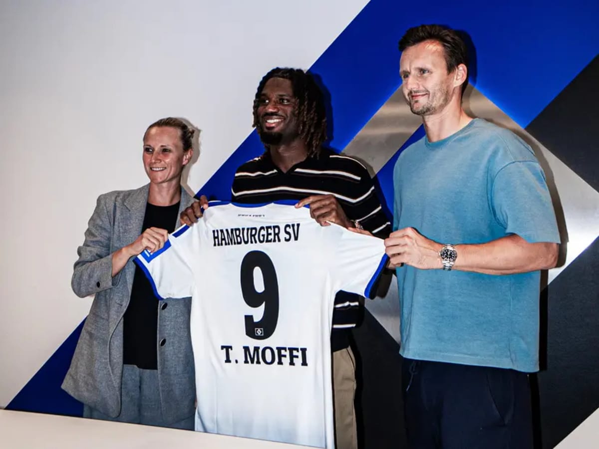 Nigerian striker Terem Moffi wearing Hamburger SV jersey holding football at training ground