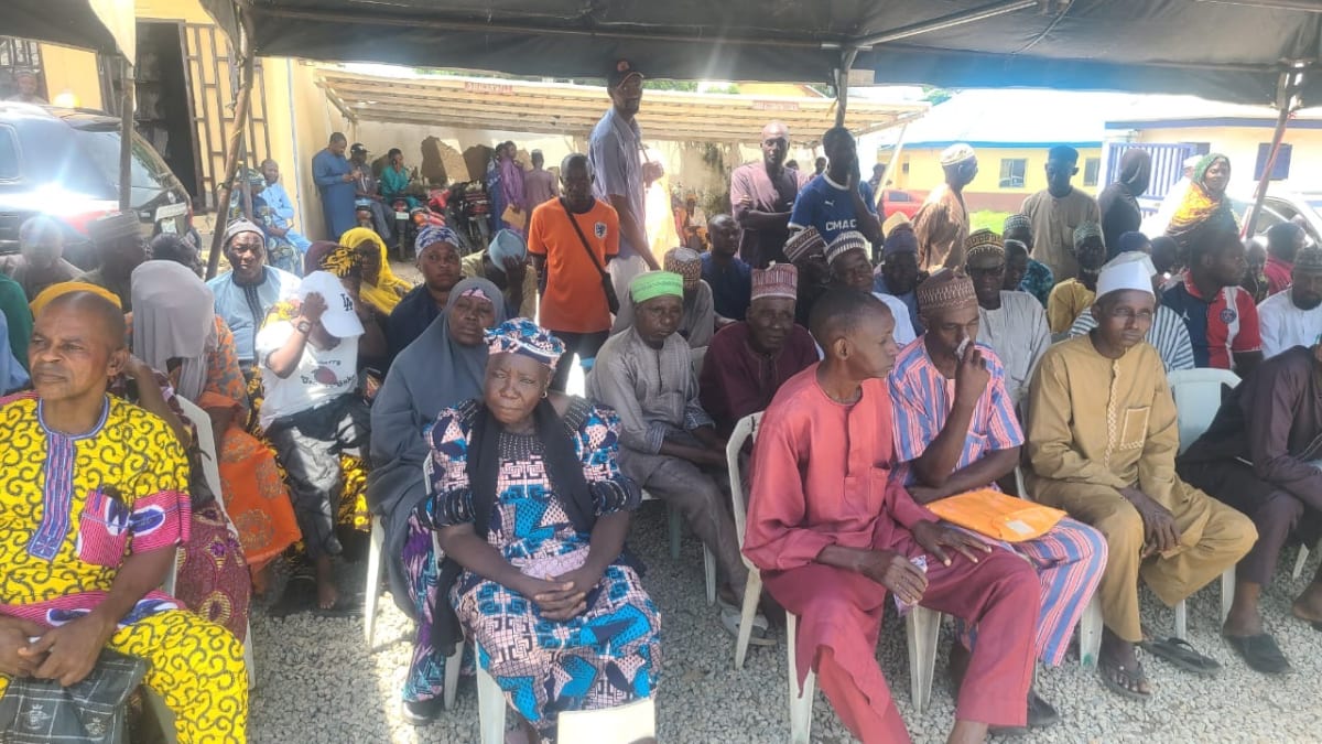 Elderly Nigerian retirees holding payment checks after receiving long-awaited government gratuities in Niger State