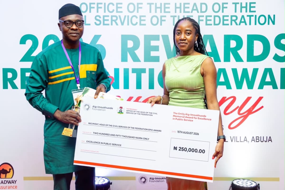 Nigerian education officer Abumoye Emmanuel celebrates award with robotics students at government ceremony