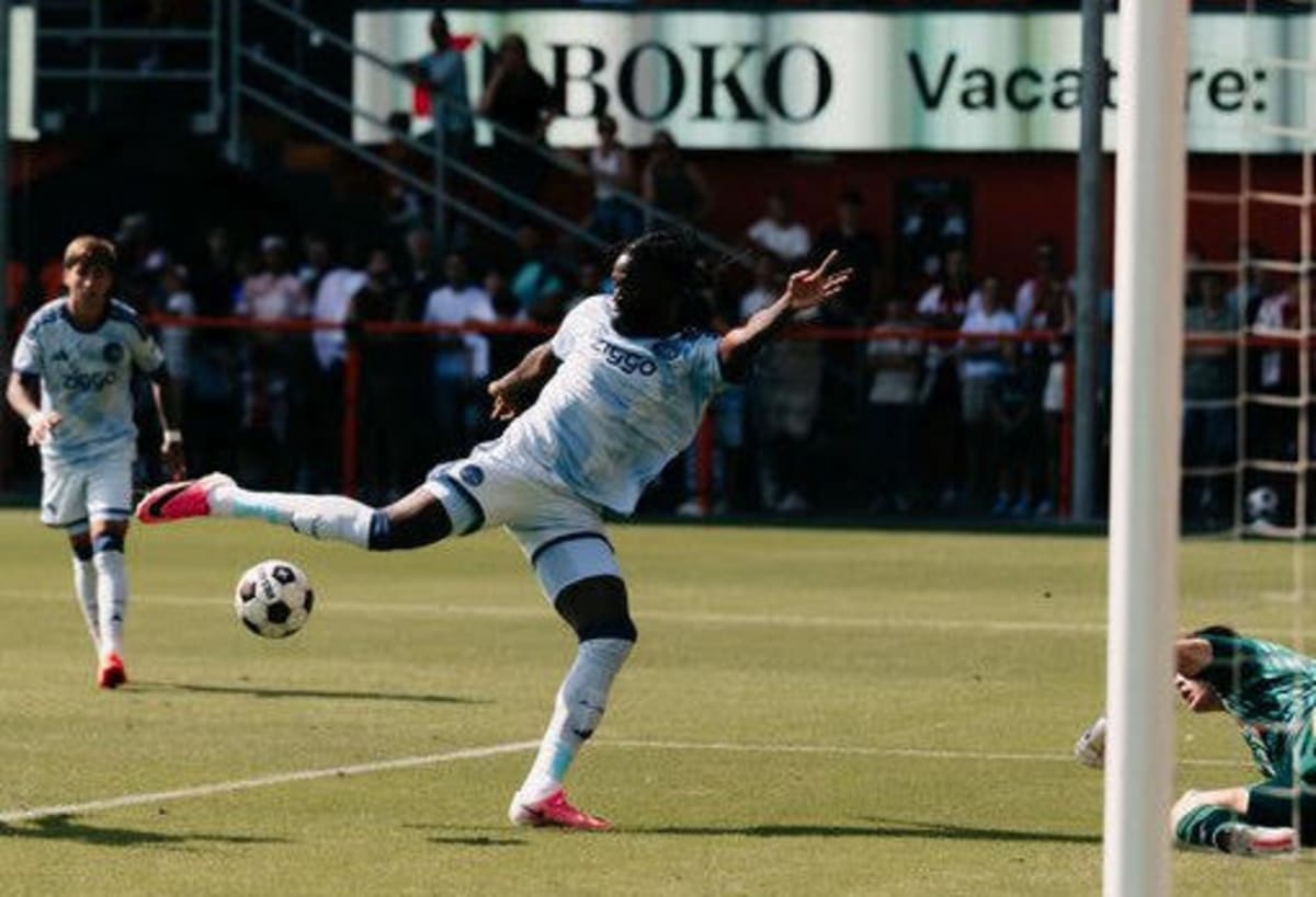 Nigerian soccer player Tolu Arokodare celebrating in Ajax Amsterdam red and white uniform