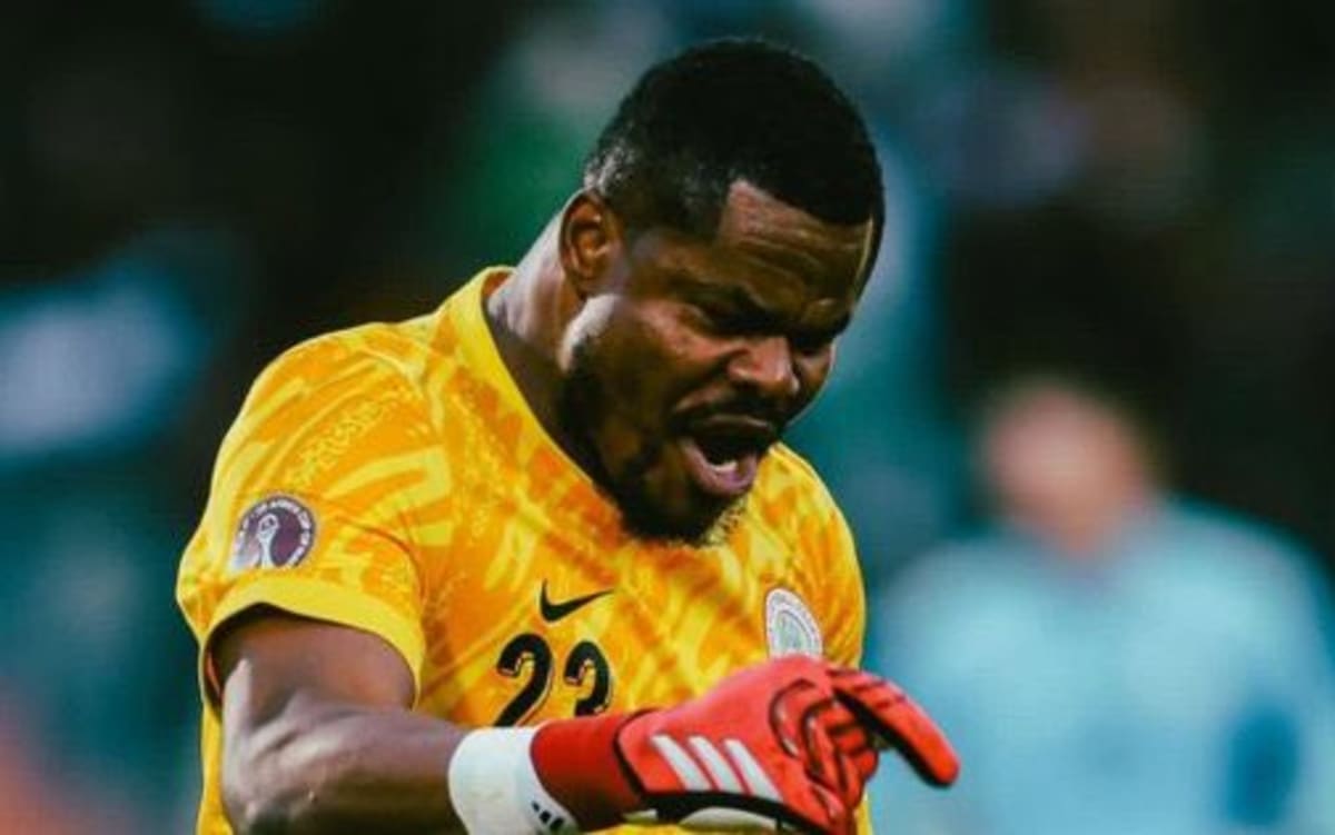 ** Nigeria Super Eagles goalkeeper Stanley Nwabali preparing for international football match in green jersey