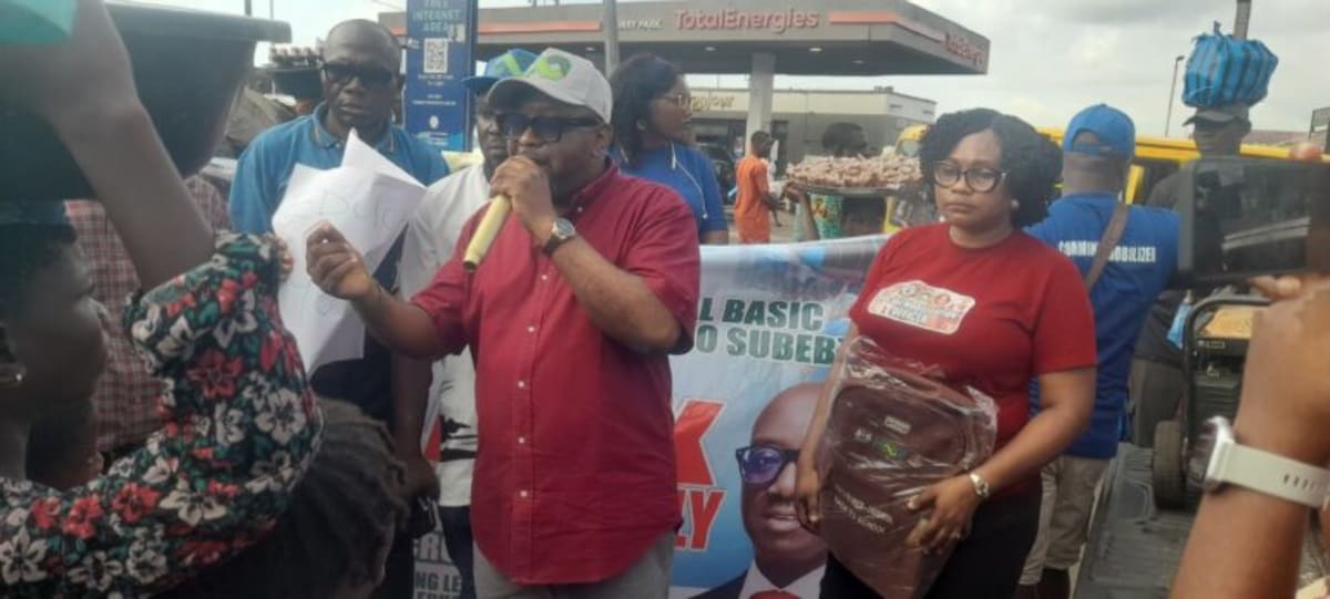 ** Nigerian students receiving colorful backpacks and school supplies from education officials in Benin City