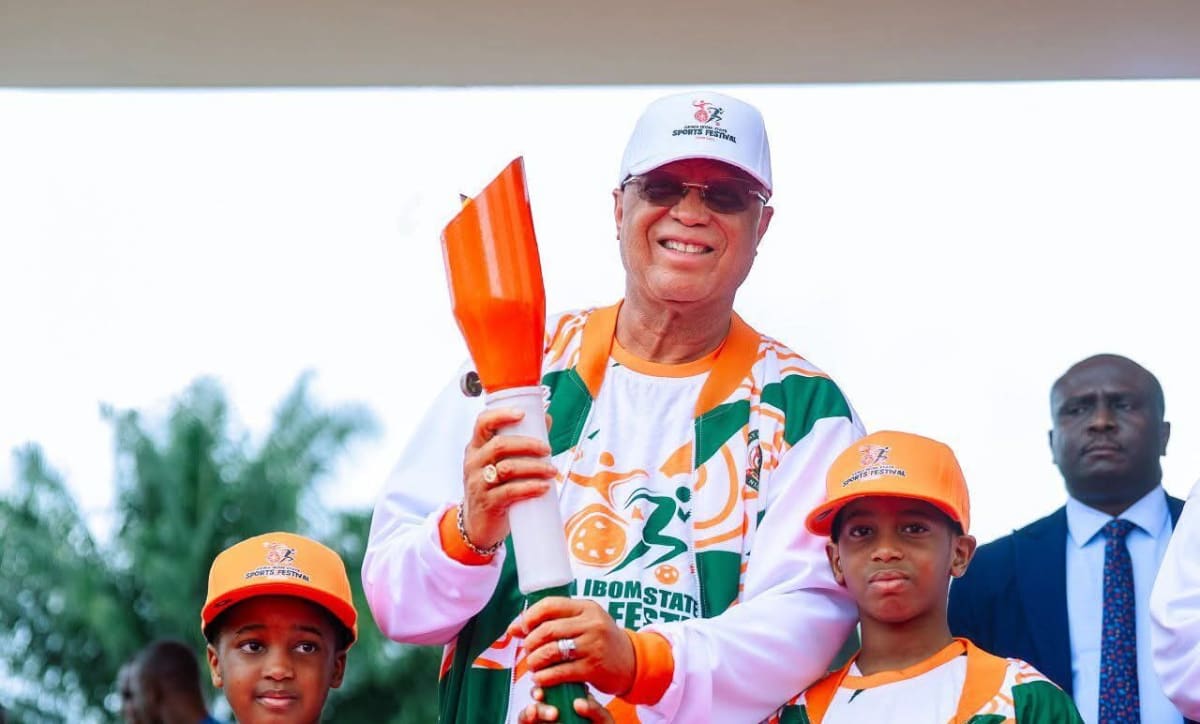 Nigerian weightlifter and judoka celebrating with medals at sports ceremony in Akwa Ibom State
