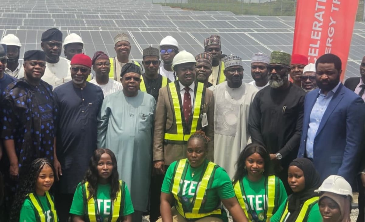 Solar panel arrays installed at Nigerian university campus with students walking between buildings