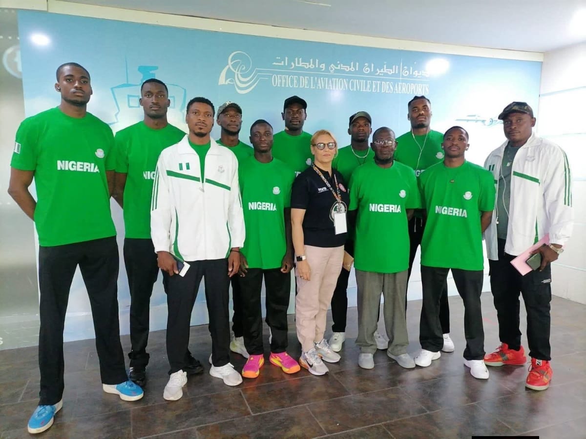 ** Nigerian men's volleyball team players preparing for African championship match in Tunisia gymnasium