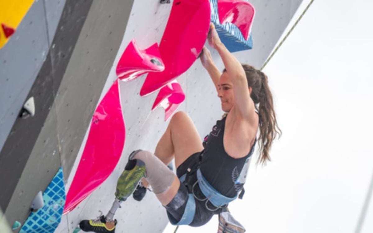 ** New Zealand paraclimber Rachel Māia training on indoor climbing wall with adaptive equipment