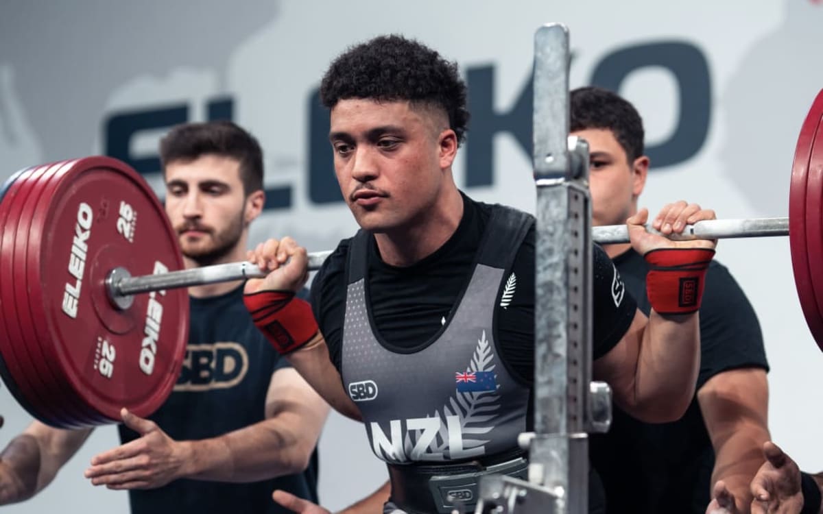 ** Young Māori teenager preparing for powerlifting competition while wearing traditional cultural symbols