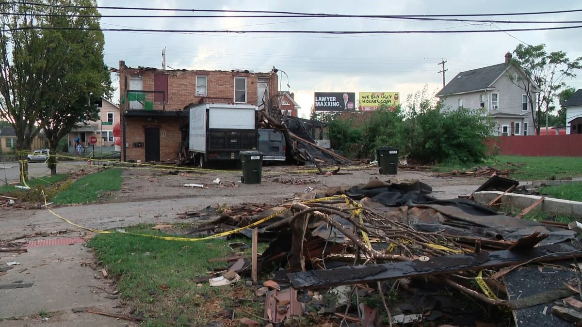 Volunteers in rain gear clearing tornado debris from sidewalks in south Columbus neighborhood