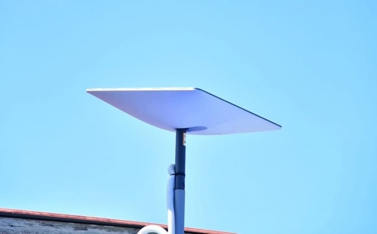 Satellite orbiting above Earth connecting to mobile devices on ground in rural area