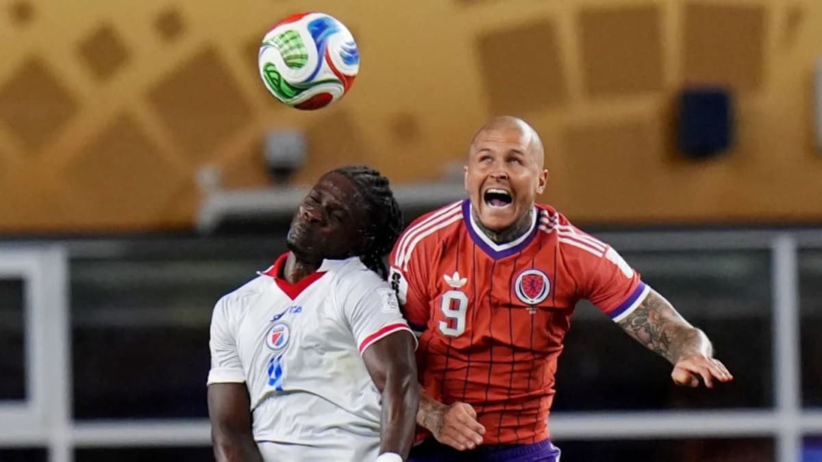 Scottish soccer players celebrating historic World Cup victory over Haiti on field