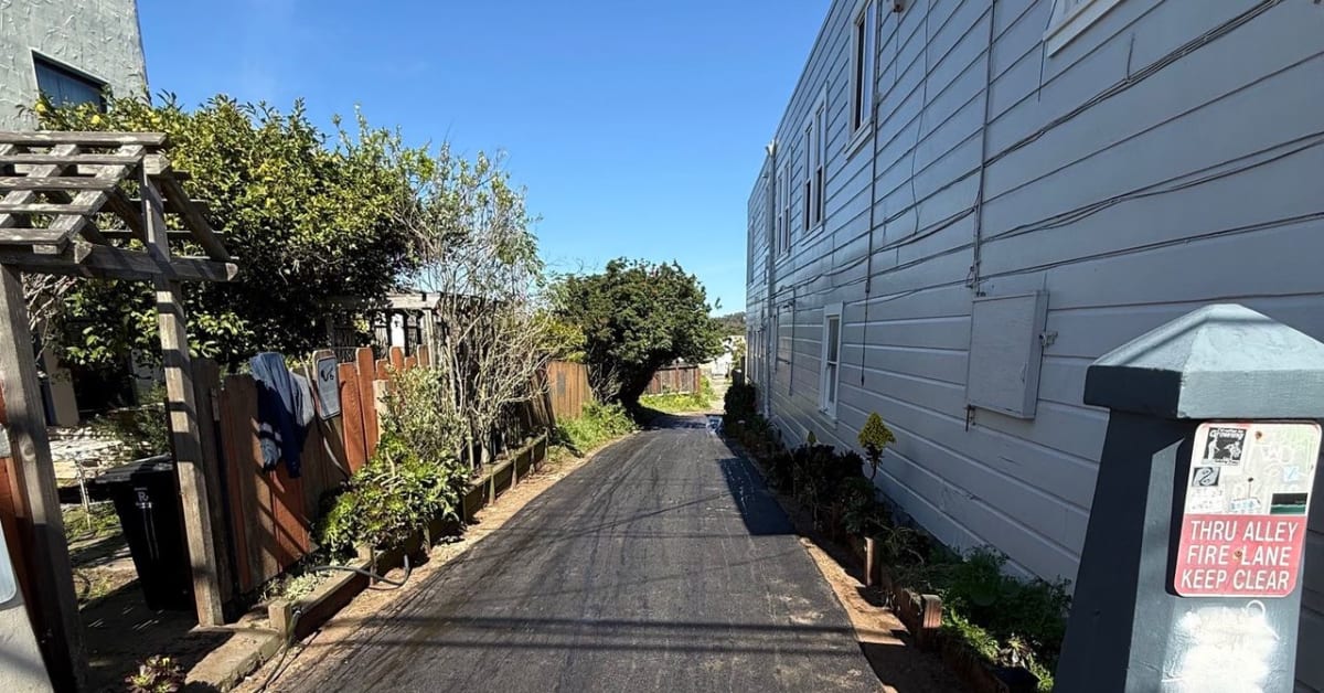 Narrow San Francisco alley with fresh pavement ready for community art installation
