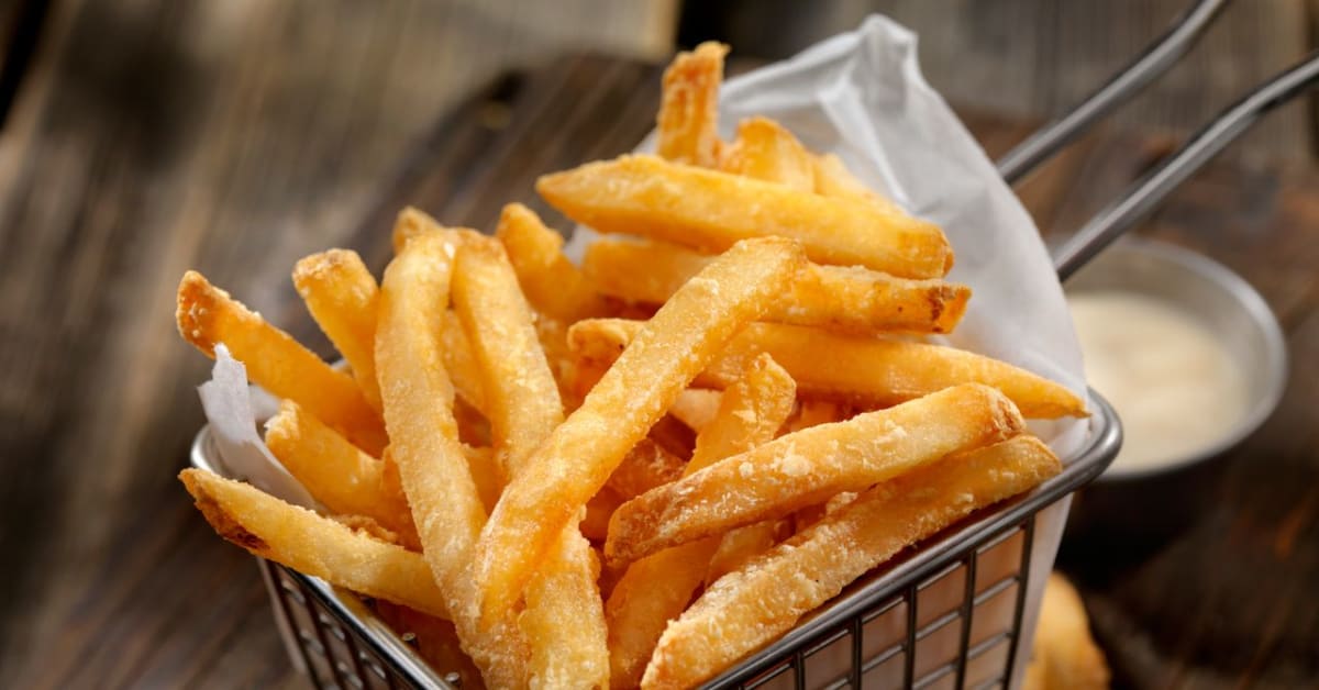 Golden crispy french fries being prepared in innovative microwave fryer combining traditional and modern cooking methods