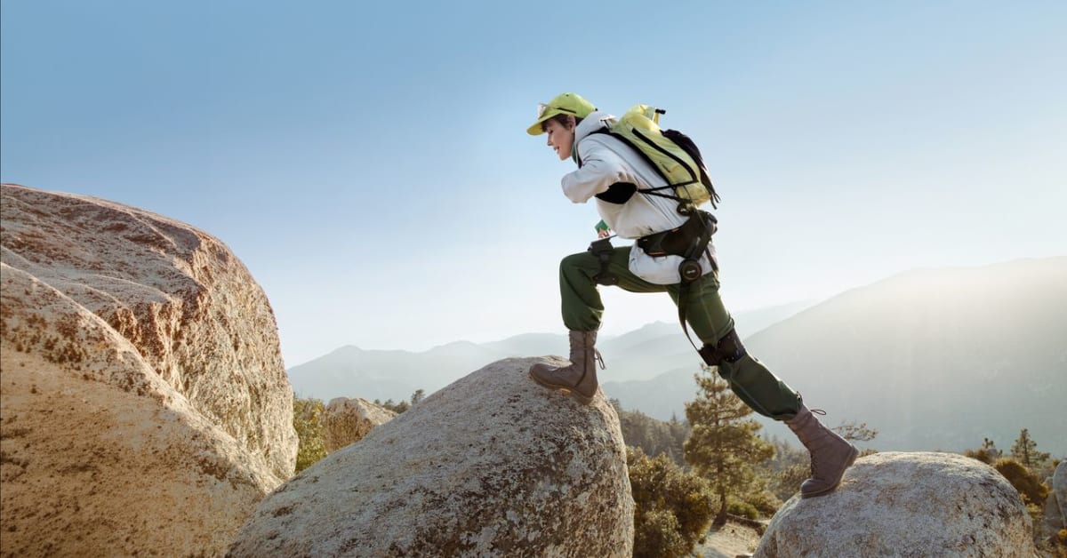 Person wearing lightweight carbon fiber Hypershell exoskeleton on hips while walking outdoors