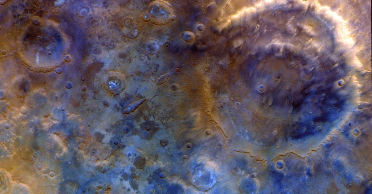 Detailed Mars surface photograph showing craters and terrain captured by NASA Psyche spacecraft