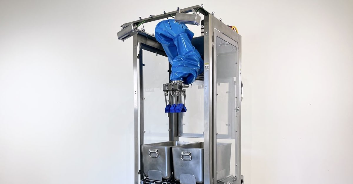 Robot arm placing food portions onto meal trays in nonprofit kitchen assembly line