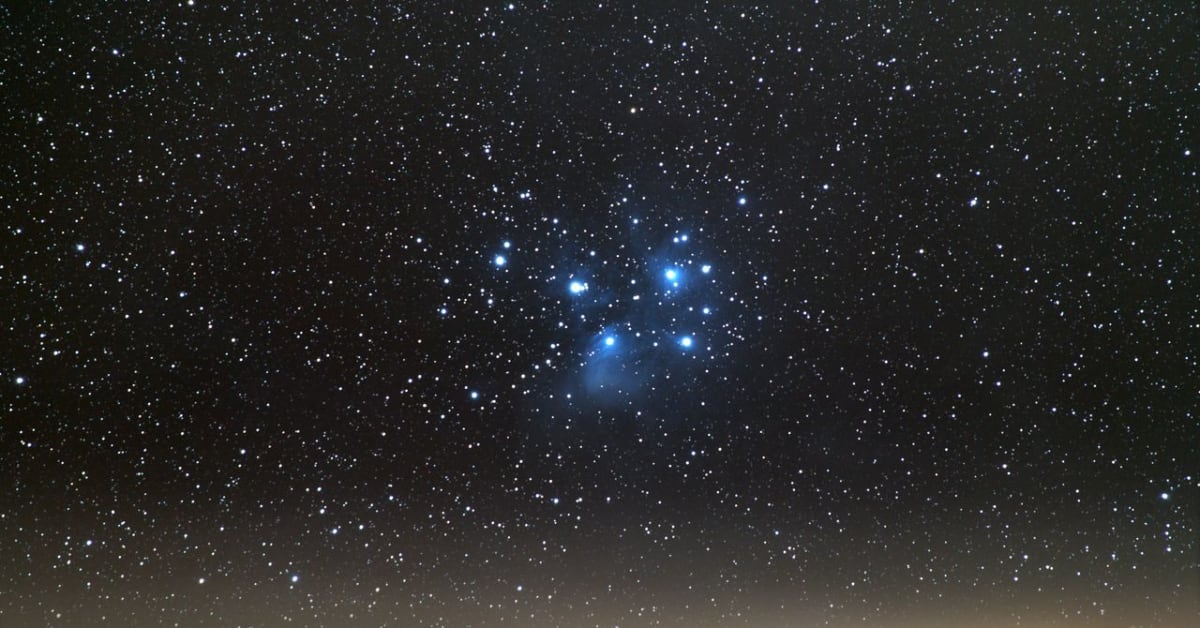 Glowing Venus and stars visible in dark night sky above horizon