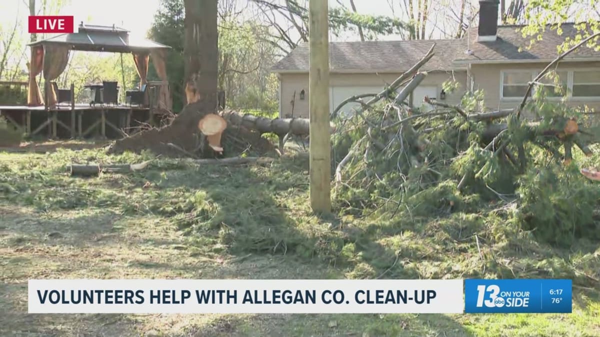 ** Volunteers clearing fallen trees and storm debris in Allegan County Michigan after tornado damage