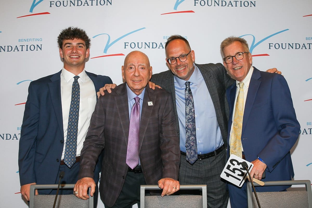 Dick Vitale surrounded by smiling young cancer survivors at his annual charity gala