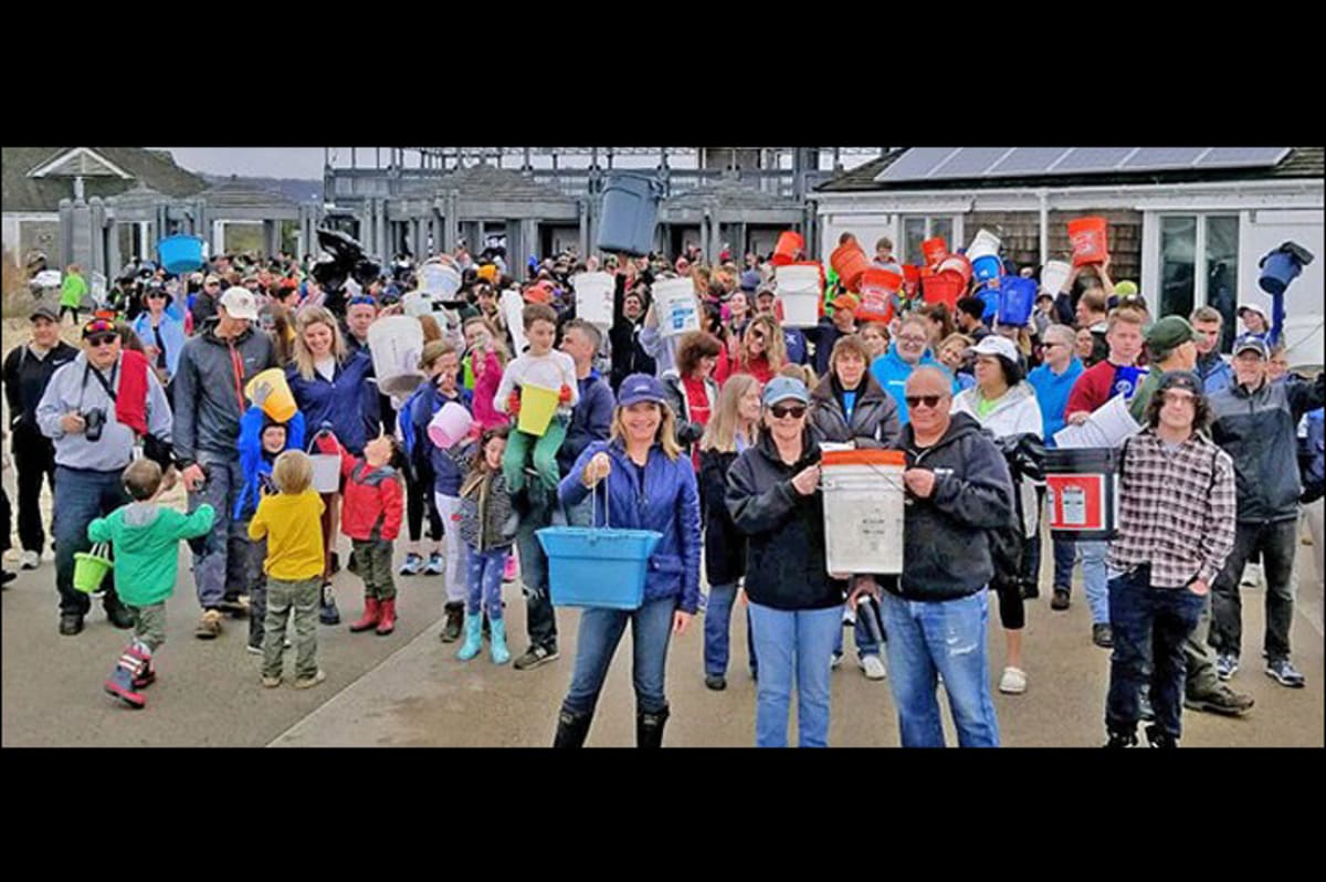 Volunteers collecting plastic debris and trash during beach cleanup along New Jersey coastline