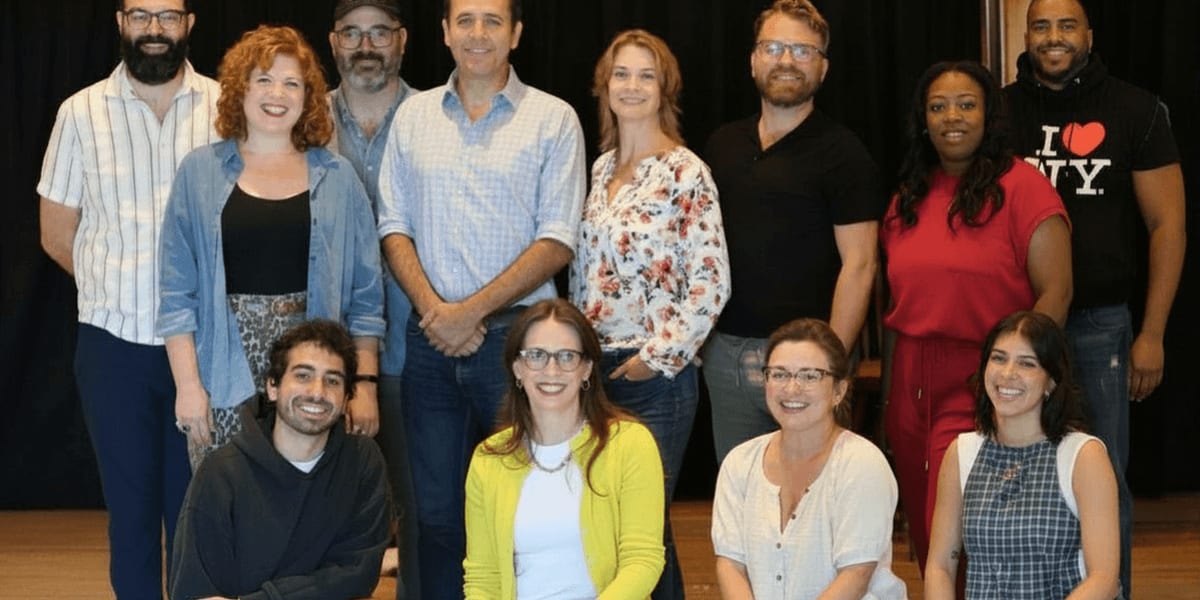 Twelve actors from Come From Away cast pose together during rehearsal at Sharon Playhouse