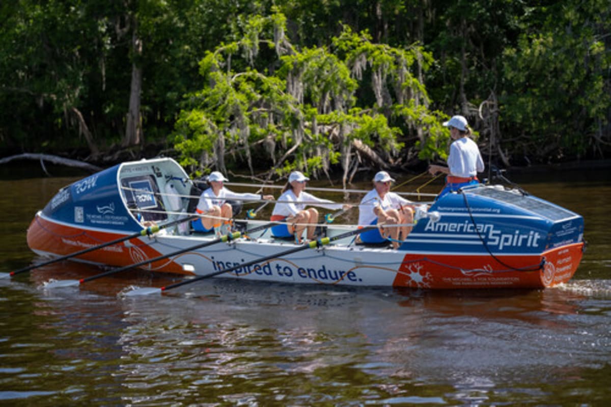 Female rowing team training on boat in Florida river for Parkinson's fundraising journey