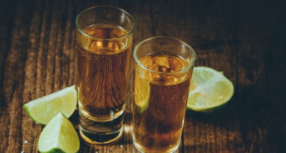 Large crowd of diverse people gathered together celebrating and raising glasses in unison