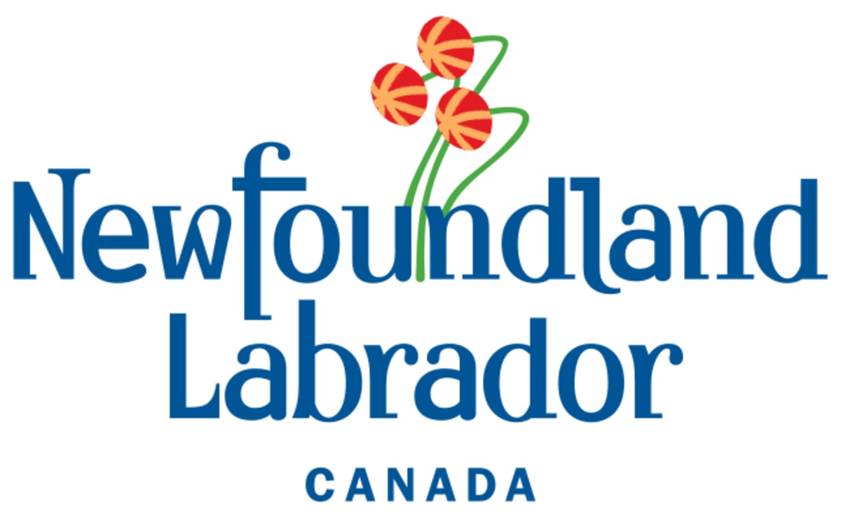 Community members gathering around table for poverty reduction planning session in Newfoundland