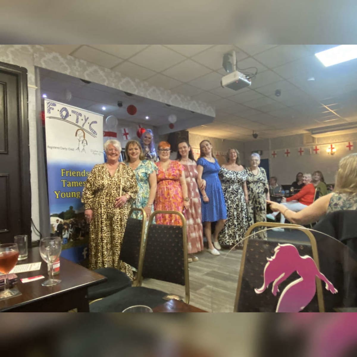 Young people modeling clothing at community fashion show fundraiser for Tameside Young Carers charity