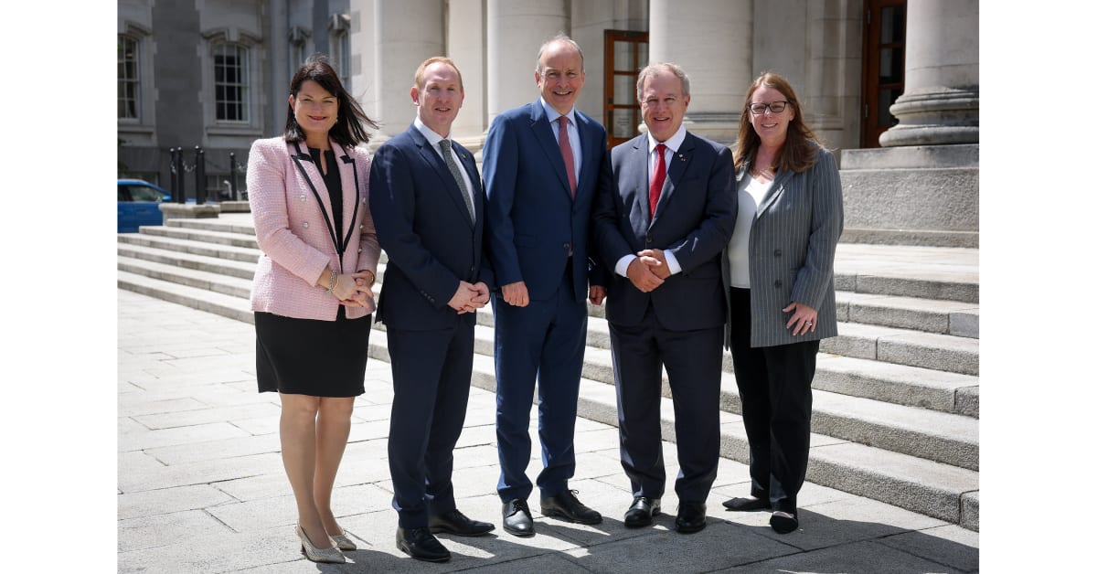 Irish and Canadian officials celebrate OpenText's job creation announcement in Dublin with handshakes