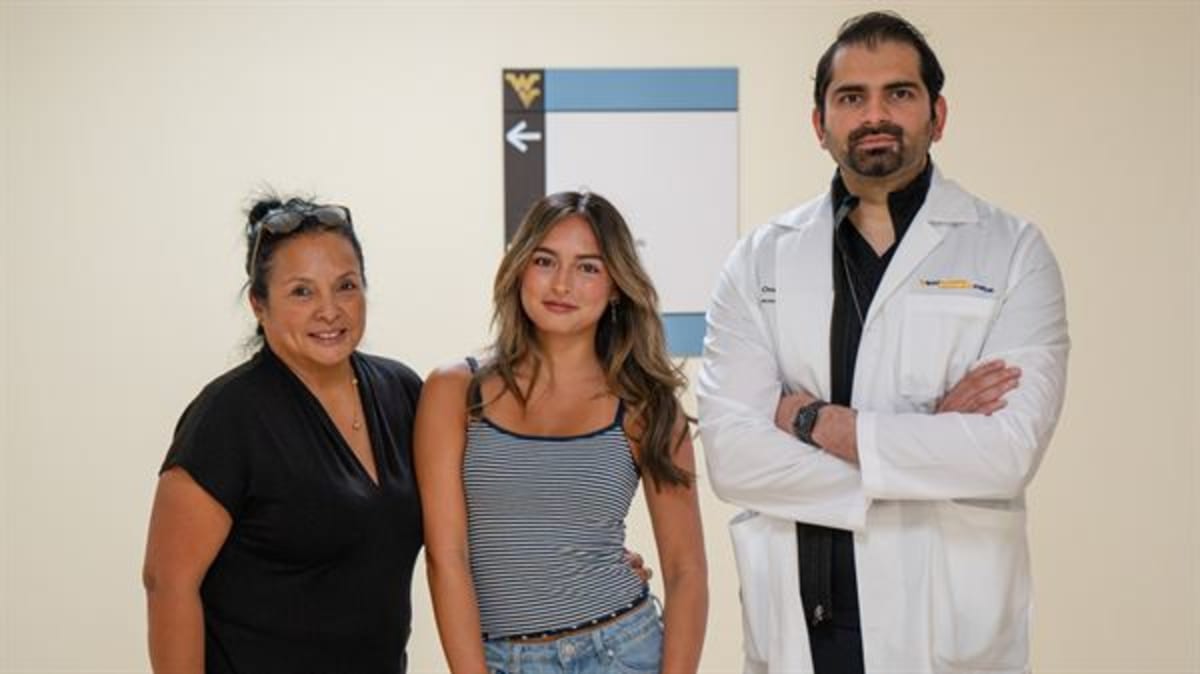 Young woman smiling after recovering from rare flu-related brain inflammation at hospital