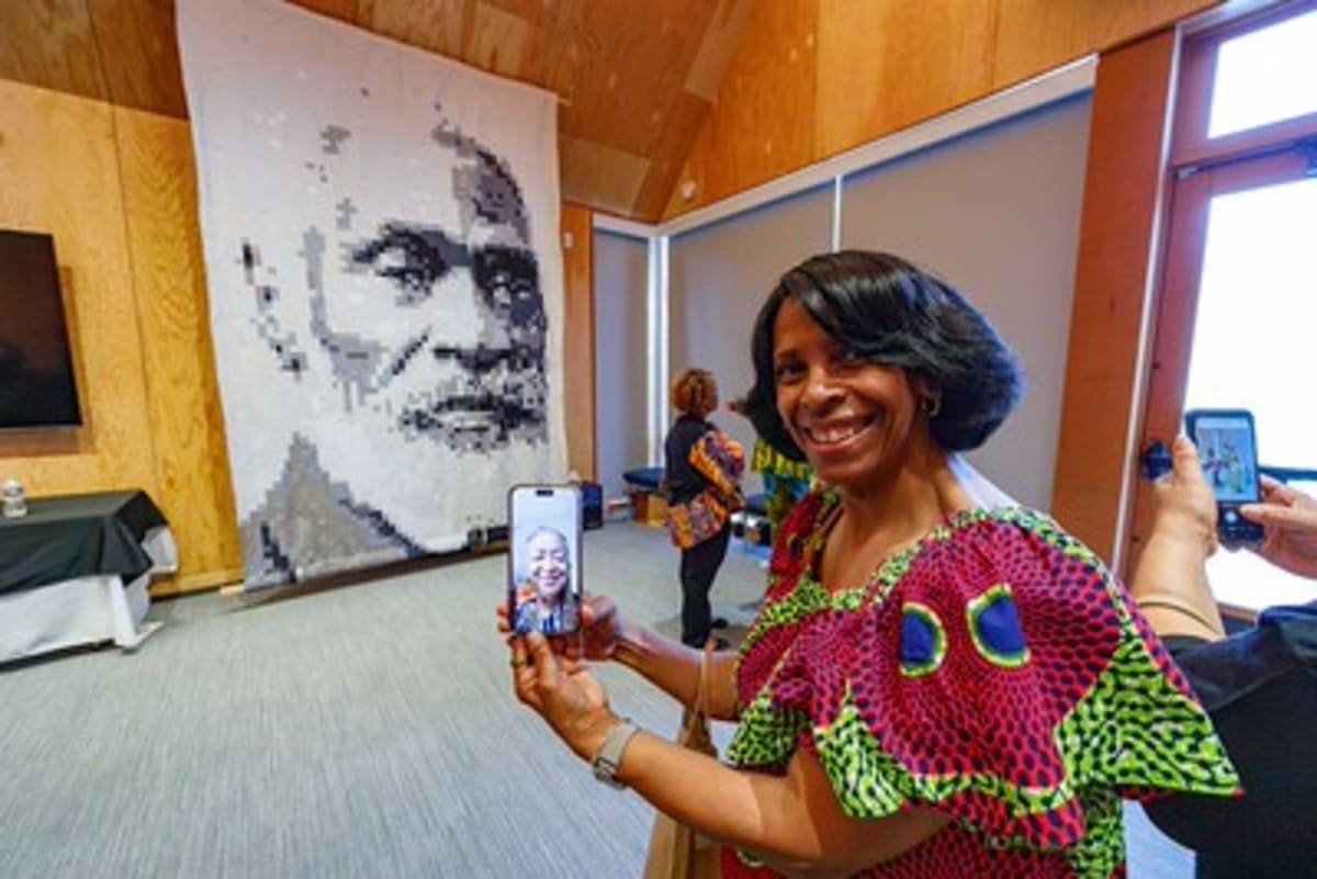 Memorial quilt showing pixelated portrait of Reverend Josiah Henson displayed at Maryland museum