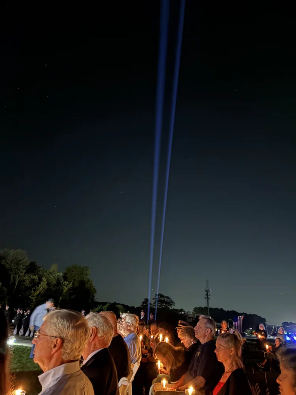 Two beams of light shine upward representing the twin towers at 9/11 memorial ceremony