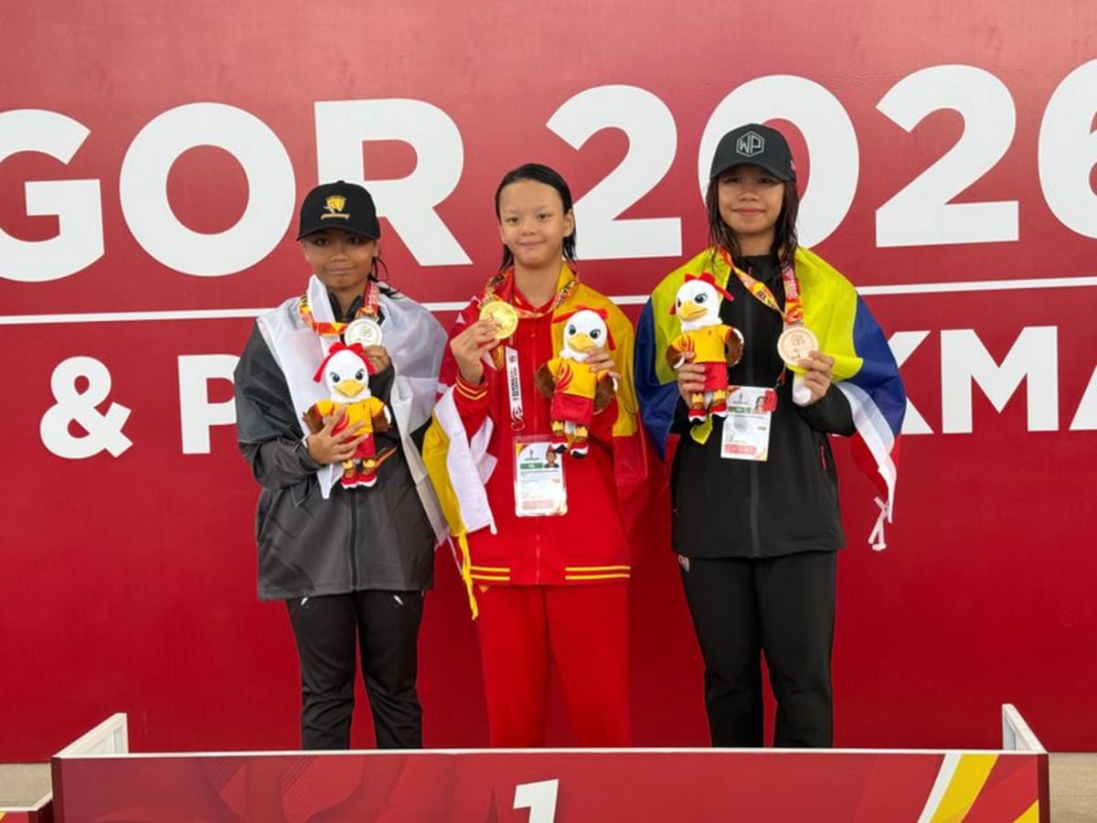 Young Malaysian para swimmer Alysha Aryana celebrating gold medal victory at competition