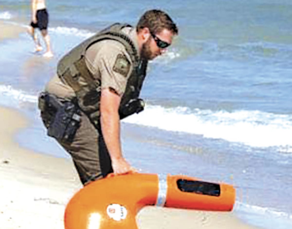 Remote-controlled water rescue device deployed in ocean waters during emergency beach rescue operation