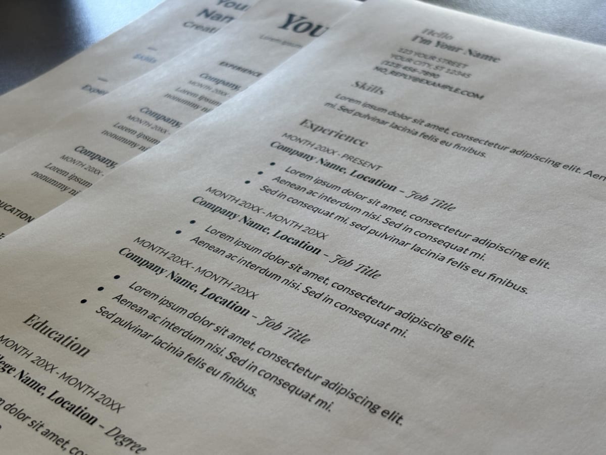 Person reviewing job application materials and resume templates at desk in Washington state